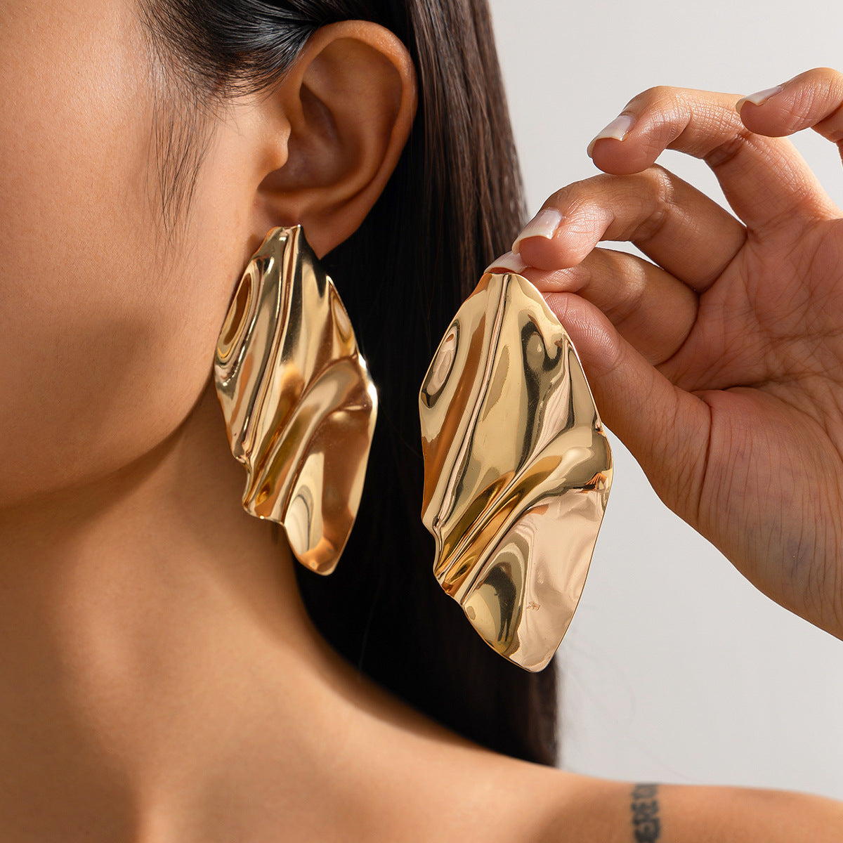Fashion Metal Texture Glossy Earrings showcasing pleated irregular geometry design with a shiny silver finish.