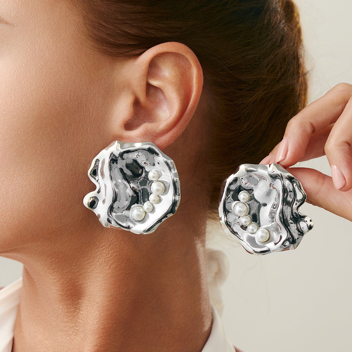 Fashion Metal Texture Glossy Earrings showcasing pleated irregular geometry design with a shiny silver finish.