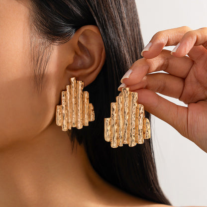 Fashion Metal Texture Glossy Earrings showcasing pleated irregular geometry design with a shiny silver finish.