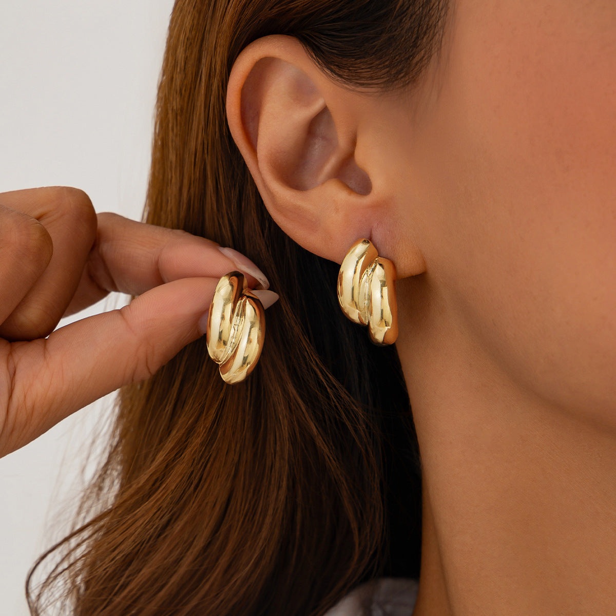 Fashion Metal Texture Glossy Earrings showcasing pleated irregular geometry design with a shiny silver finish.