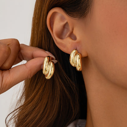 Fashion Metal Texture Glossy Earrings showcasing pleated irregular geometry design with a shiny silver finish.