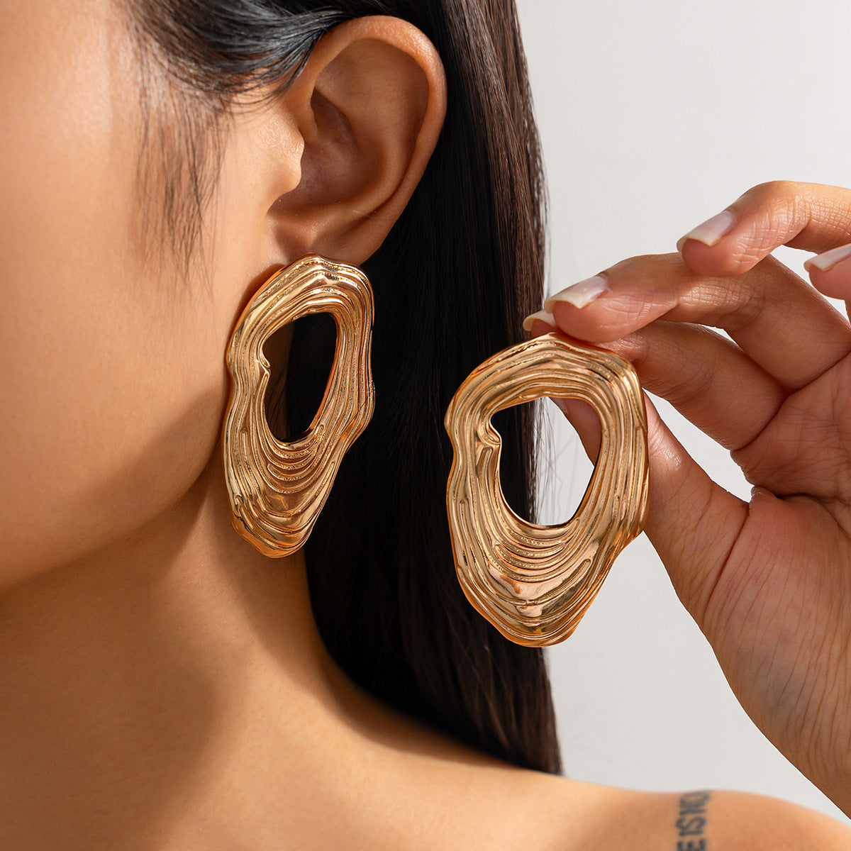 Fashion Metal Texture Glossy Earrings showcasing pleated irregular geometry design with a shiny silver finish.